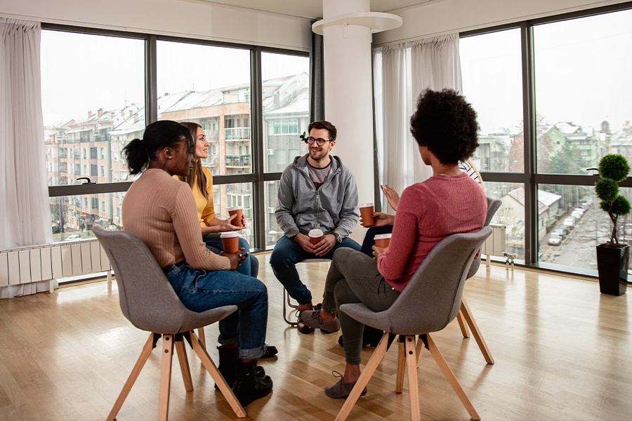 diverse group attending group therapy for addiction in a counseling session