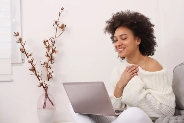 a girl uses her laptop to research alcohol rehab options online